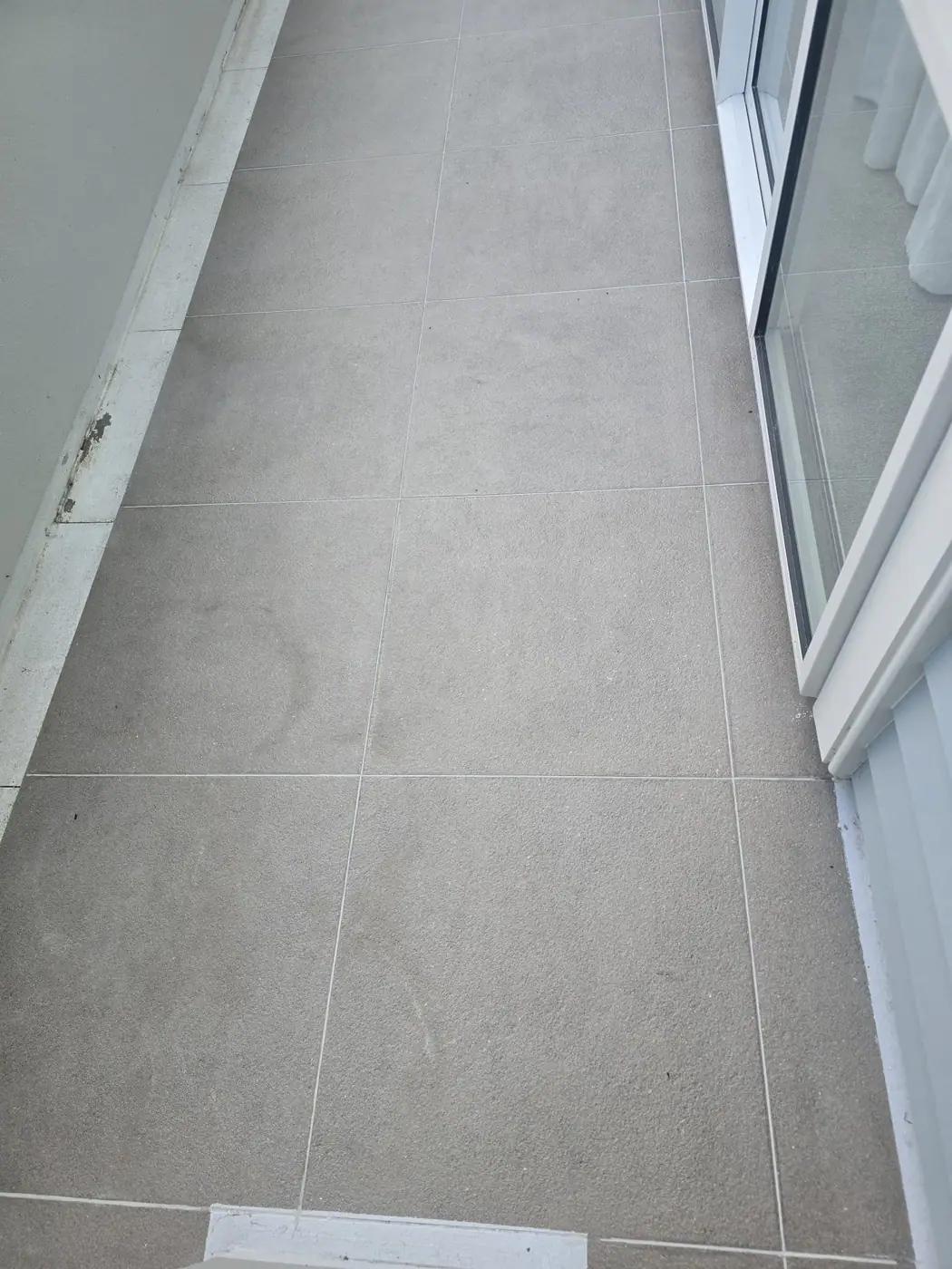 Balcony tiles after grout cleaning and restoration