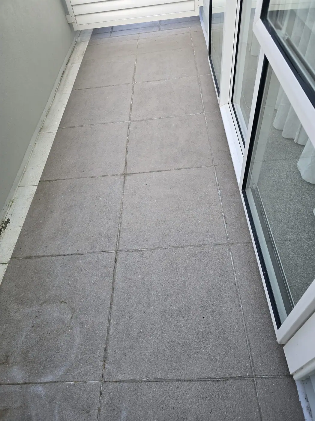 Balcony tiles before grout cleaning and restoration