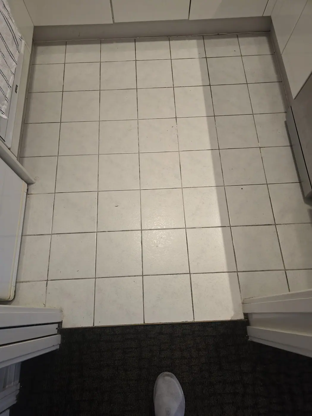 Tiled floor before grout restoration