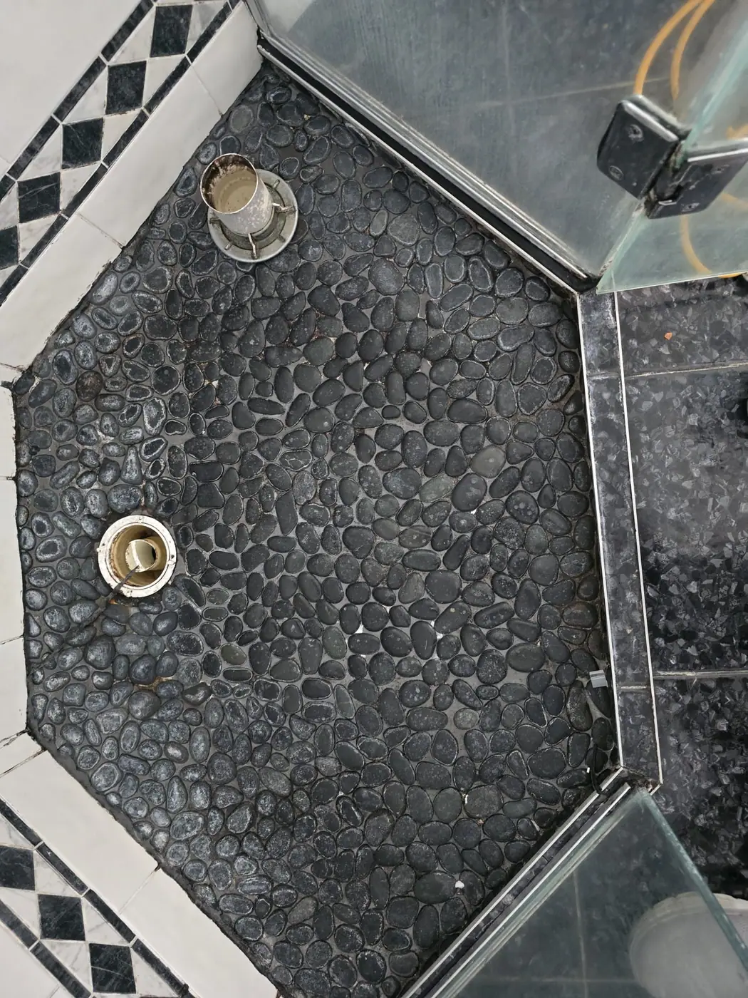 Pebble shower floor before restoration