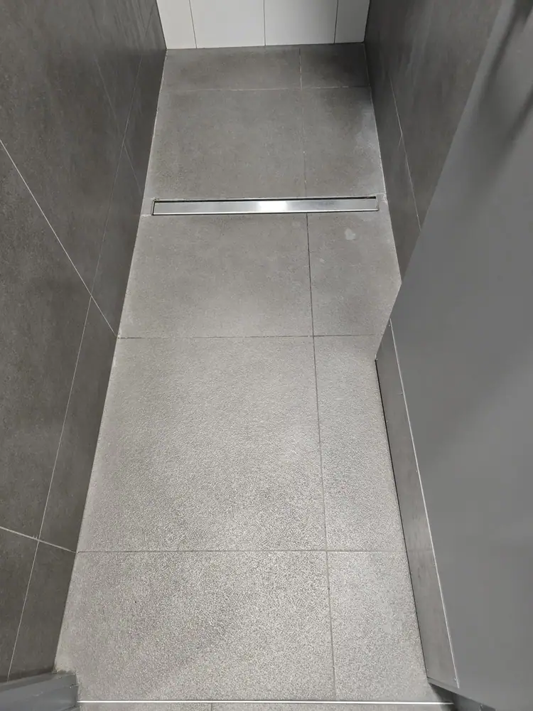 Walk-in shower floor after tile grout restoration