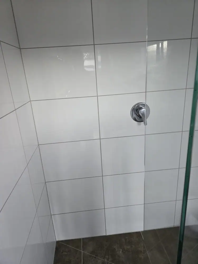 White tiled shower after grout repair