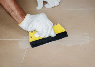 Epoxy grout being applied to a tiled floor